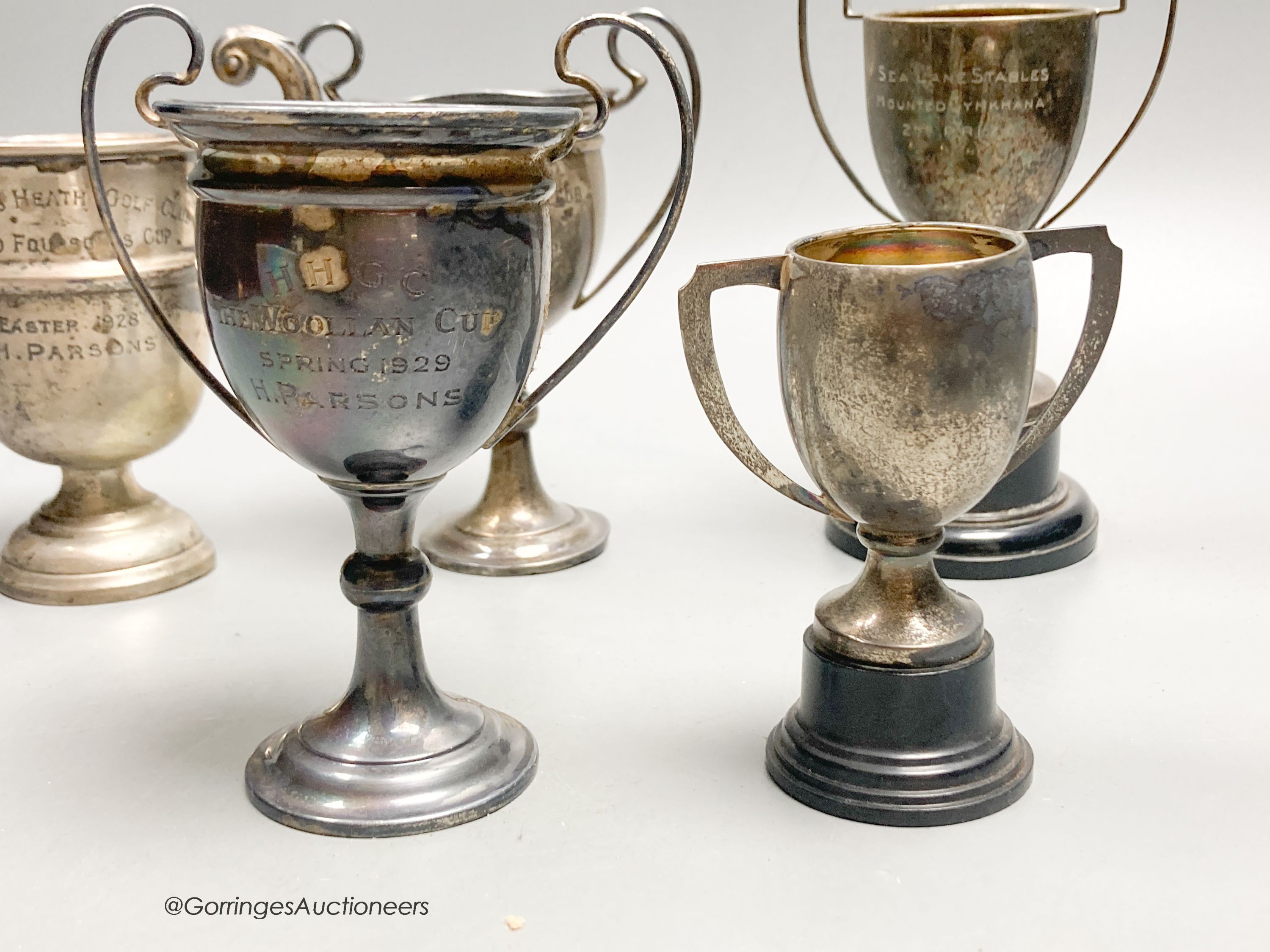 Eight assorted small silver trophy cups and one plated cup, tallest 11.3cm, 11.5oz.